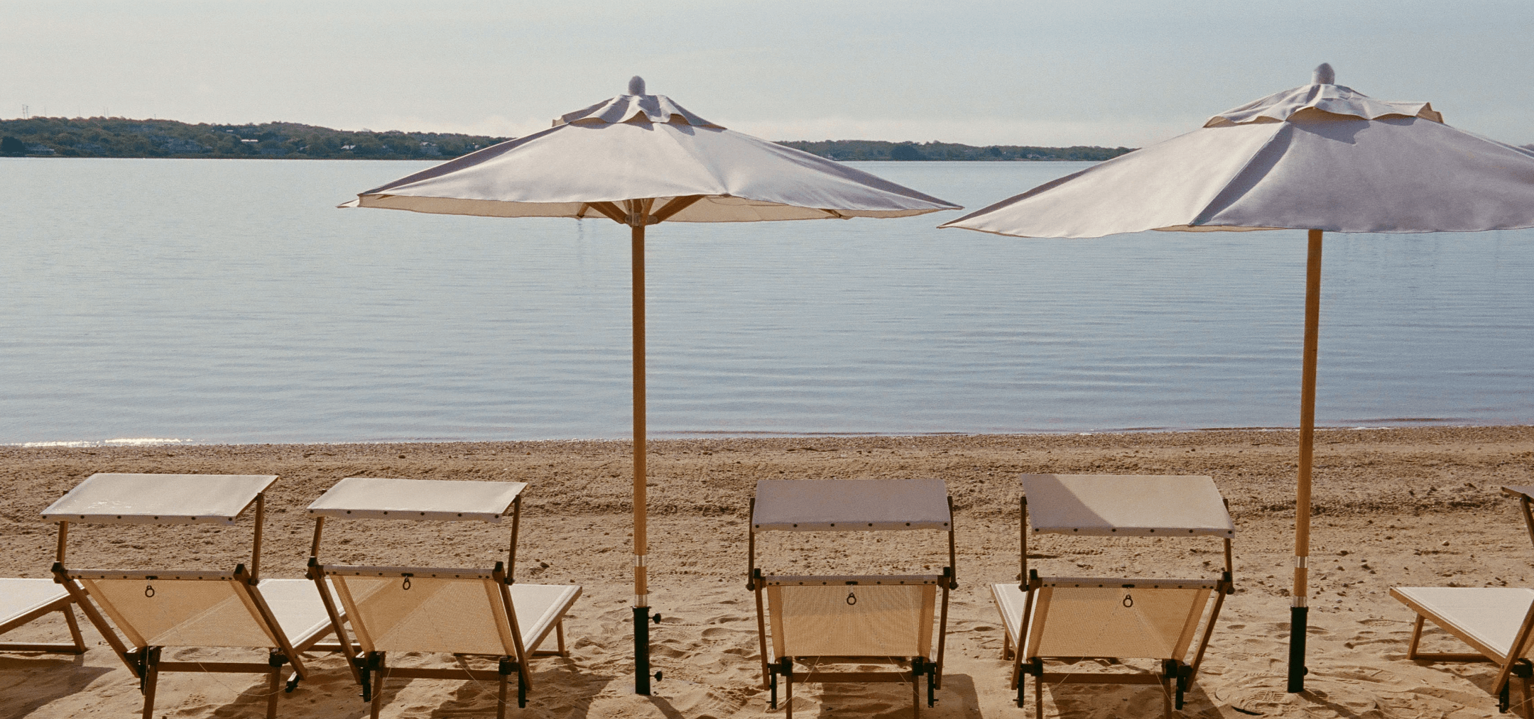 Many lounge chairs are placed along the shore, providing a splendid view of the sea.