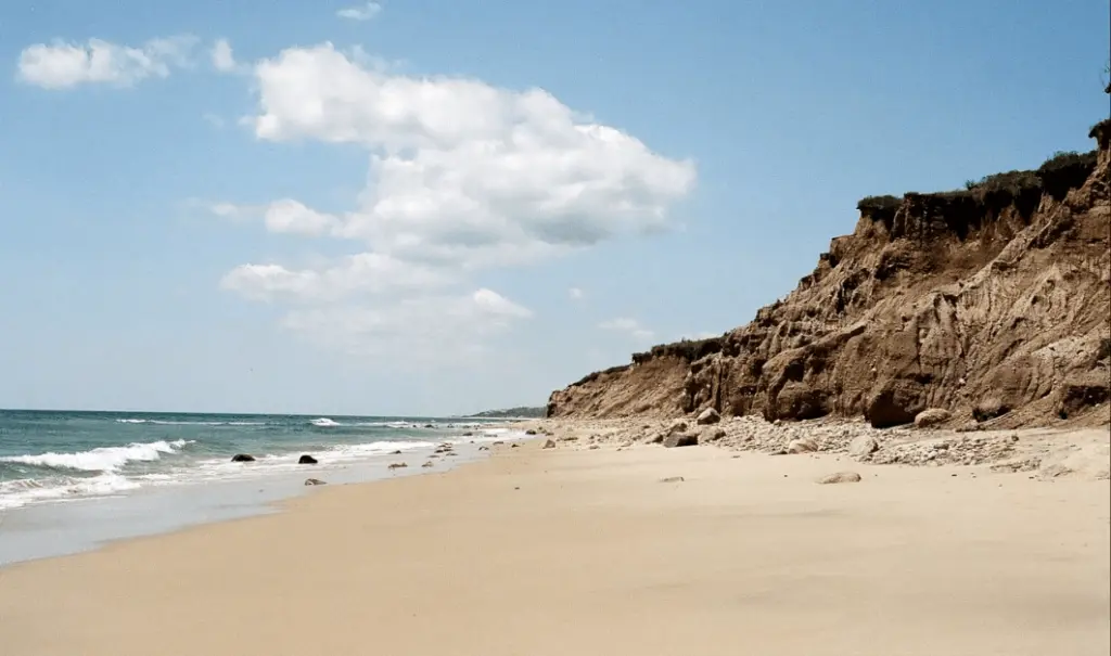 A wonderful photo of the seashore with mountains and a stunning view of the sea.