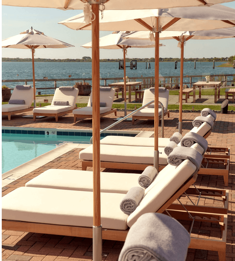 Comfortable lounge chairs arranged around the pool at the dockyard offer a scenic sea view.