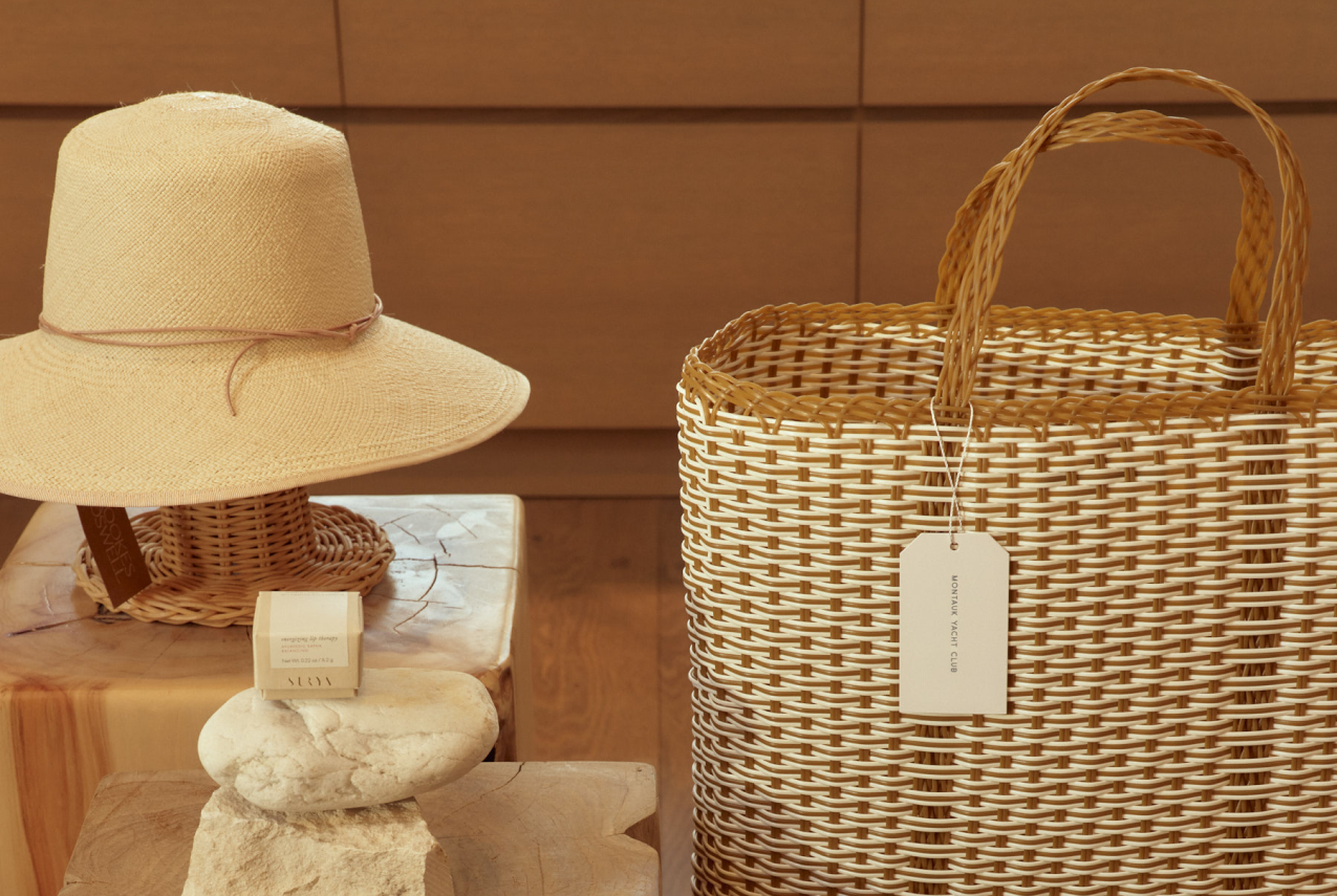 A beautifully handcrafted hat and jute bag displayed on a table for customers to admire.