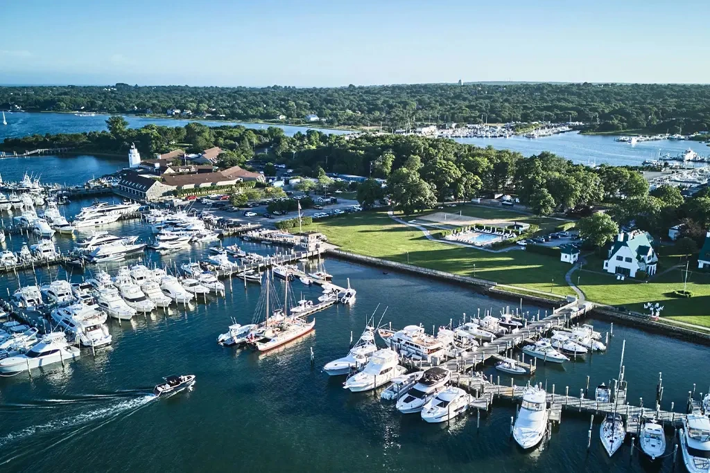 Aerial view of Montauk Yacht Club marina with boats, docks, and waterfront grounds